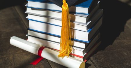 grad-cap-diploma-and-books-stacked